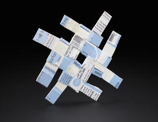 Woven mat created from cardboard light blue and white Warfarin medicine packaging
