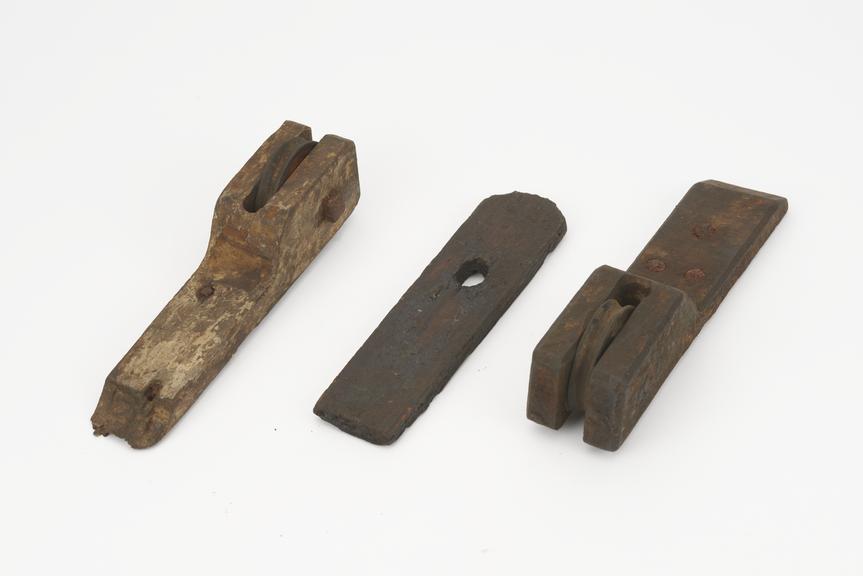 Two wooden blocks each with a wooden pulley sheave let in