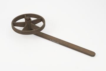 Iron wheel running on a pin on the end of an iron arm