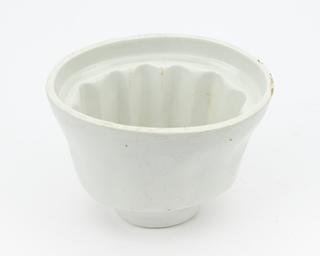 White glazed earthenware oval jelly mould