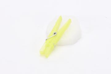 Yellow plastic clothes-peg