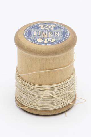 One wooden linen thread spool with white thread, 1920-1970