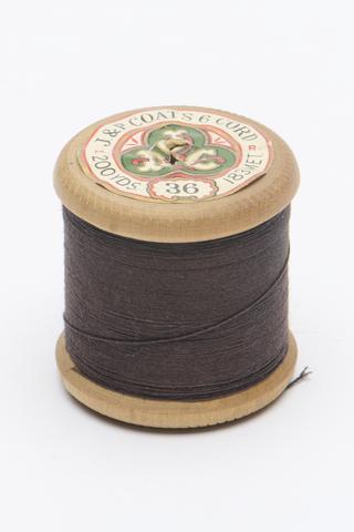 One wooden cotton thread spool with black thread by J. & P. Coats, Glasgow, 1920-1970